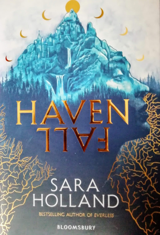 The cover a blue mountain that is shaped like a face with golden moons with the title and Sara Holland in front of it